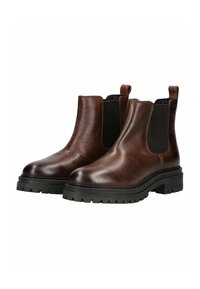Botas Chelsea de cuero marrón con paneles laterales elásticos, punta redondeada y suelas de goma negra gruesa con ranuras de tracción.