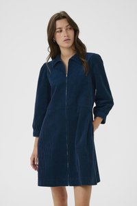 Navy-blaue Kordkleid mit Reißverschluss vorne, Kragenhals und puffärmeln. Verfügt über seitliche Taschen und eine ausgestellte Silhouette.