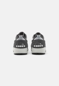 Gray suede and mesh sneakers with white rubber soles and a logo on the heel. Round toe design with padded collar and tongue accent.
