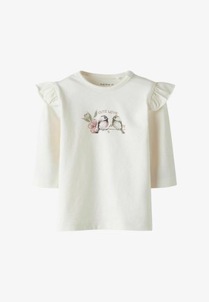 Maglietta per bambini color crema con spalle arricciate e disegno di due uccelli su un ramo con fiori rosa, con la didascalia "Cute Love".