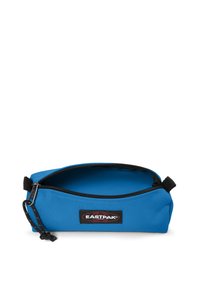 Blue Eastpak pencil case made of durable fabric, featuring a black zipper, an open design, and a logo patch on the front. Smooth texture.