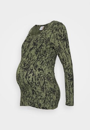 Long-sleeve maternity top in olive green with a black abstract pattern. Features stretchy fabric and a fitted silhouette designed for comfort.