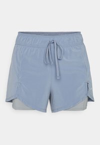 Light blue athletic shorts with an elastic waistband and drawstring, featuring an inner liner and angled side hem for mobility.