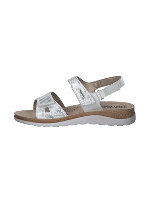 Silver sandal with synthetic upper, open toe, and adjustable strap. Cushioned insole and light-colored rubber outsole. Textured detailing present.
