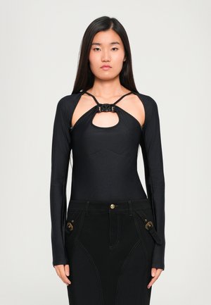 Black long-sleeve bodysuit featuring cutout detail at chest, textured fabric, slim fit, with a knot accent at the neckline, paired with black jeans.