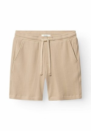 Pantalones cortos beige de punto texturizado con cintura elástica, cordón ajustable y bolsillos laterales, dispuestos planos sobre un fondo blanco.