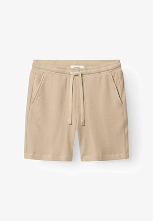 Beežid tekstuuriga kootud lühikesed püksid elastse vöörihma, paelaga ja küljetaskutega, laotatult valgele taustale.