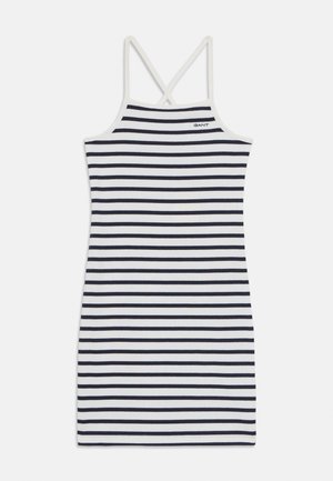 Ermeløs kjole med en tettsittende silhuett, laget av mykt stoff, med horisontale marineblå og hvite striper, og kryssete rygger.