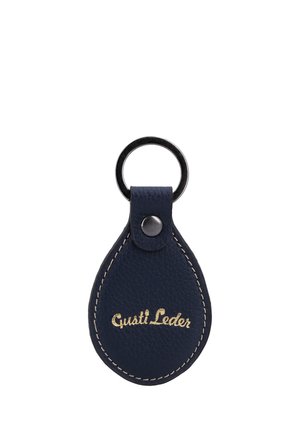Llavero de cuero azul oscuro con forma de lágrima, con costuras blancas, anilla metálica y logo dorado "Gusti Leder" en la parte frontal.
