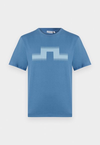 Blå bomulls-T-skjorte med et gradient geometrisk mønster i lysere blått på forsiden. Kortermet og rund hals.