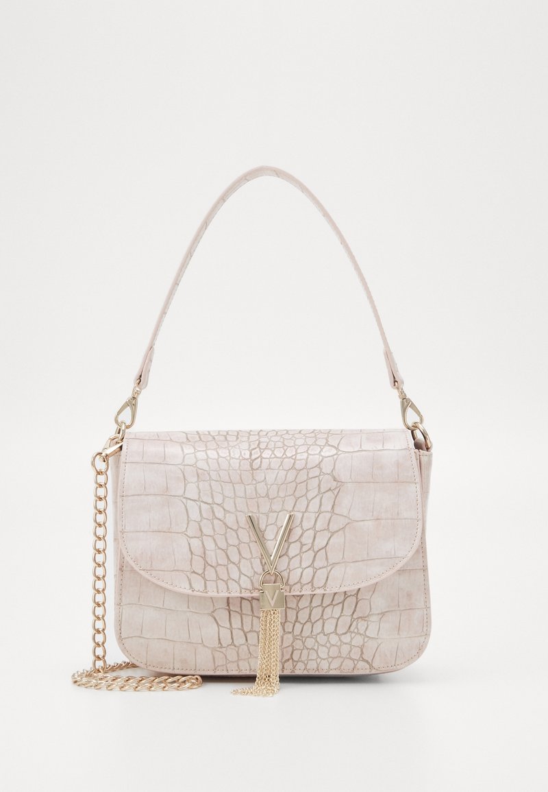 Light pink crocodile-patterned handbag with a gold chain strap and decorative tassel. Features a front flap and a central logo accent.