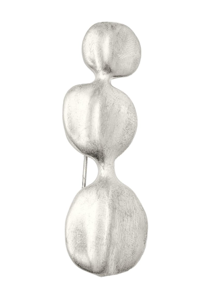 Silver metal brooch featuring an abstract design with three rounded shapes, smooth texture, and a subtle matte finish.
