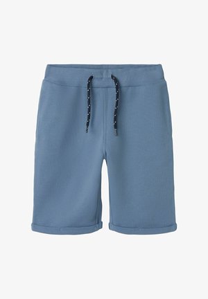 Blue cotton shorts with a ribbed waistband, adjustable drawstring in navy with white dots, and folded cuffs at the hem.