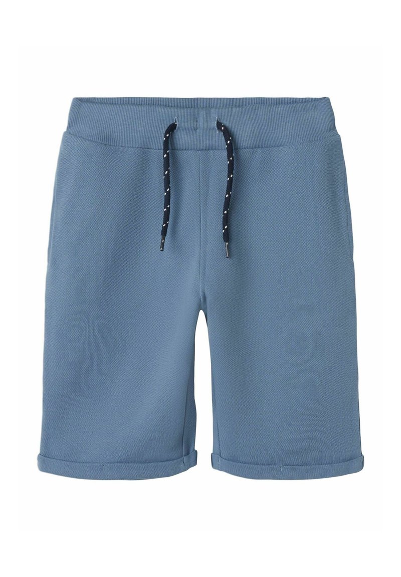 Blå bomullsshorts med ribbad midjeresår, justerbar snörning i marinblått med vita prickar, och uppvikt fåll vid nederkanten.