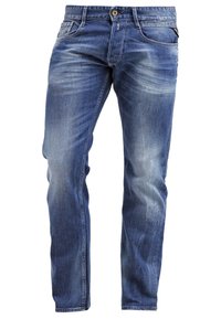 Jeans i denim i medelblått med en blekt tvätt. Har en rak passform, fem fickor och knappstängning. Slitna detaljer på benen.