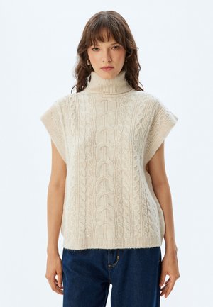 Beige Kabelstrick-Turtleneck-Pullover mit kurzen Ärmeln, der über kunstvolle strukturierte Muster und eine lockere Passform verfügt. Aus weichem Woll-Mischgewebe.