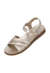 Metallisch goldene Sandalen mit flacher Sohle, die überkreuzte Riemen und einen verstellbaren Knöchelriemen mit einer runden Schnalle verfügen.