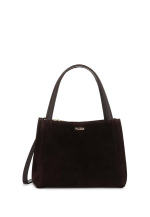 Sac à main en daim noir avec double poignée supérieure, une fine bandoulière et un petit logo doré "kazar" au centre avant.