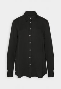 Chemise noire à manches longues avec boutons, fabriquée en tissu lisse, dotée d'un col pointu et de boutons argentés sur le devant. L'ourlet est légèrement arrondi.