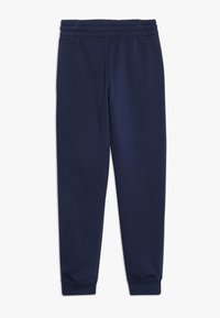 Mörkblå sweatpants i mjuk bomullsblandning, med elastisk midja, sidofickor och avsmalnande mudd vid anklarna.