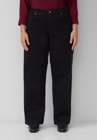 Czarne dżinsy o szerokich nogawkach i wysokim stanie, ozdobione przednimi kieszeniami oraz metalowym zapięciem na guzik. Gładka tekstura, materiał z domieszką bawełny.