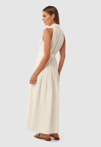 Vestido branco sem mangas, ajustado à cintura, com gola e saia plissada fluida. Tecido suave e design minimalista.