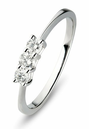 Slim silver ring with three round-cut diamonds set in a row on a white background.