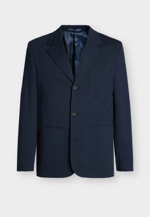 Marineblå blazer laget av strukturert stoff, med skjært krage, tre brune knapper og to frontlommer. Glatt indre fôr.