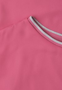 Close-up of a pink fabric garment with a round neckline featuring ribbed trim with silver and white stripes.