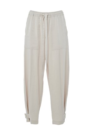 Pantaloni leggeri beige, comodi e svasati, con vita elastica, chiusura con cordoncino e due grandi tasche frontali. I polsini sono fissati con bottoni.