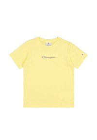 Camiseta amarilla de manga corta hecha de algodón suave, con un ligero bordado del logo "Champion" en azul. Diseño minimalista, cuello redondo clásico.