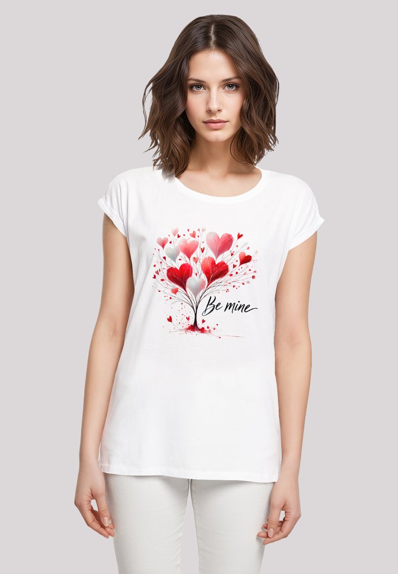 White cotton t-shirt featuring a colorful heart tree design in red and pink, with the handwritten text "Be mine" underneath. Short sleeves.