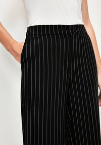 adL WIDE  - Pantaloni - striped black