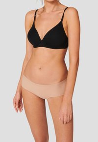 Black soft fabric bra with a v-shaped design and adjustable straps paired with nude seamless hipster briefs, showcasing smooth textures.