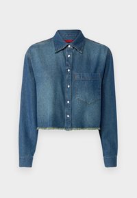 Giacca di jeans cropped in blu scuro, con colletto a punta, chiusura frontale a bottoni, taschino singolo sul petto e orlo sfrangiato.