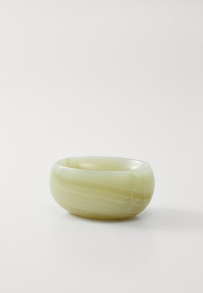 Round, pale green stone bowl with a smooth finish, featuring subtle lighter stripes and a polished texture.