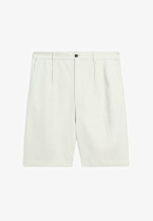 Light beige shorts made from a textured fabric. Features a front pleat, belt loops, and a black button closure. Hemmed at the knee.