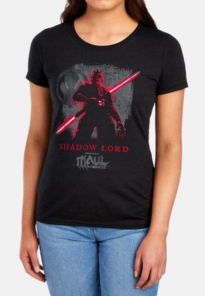 Woman wearing a black T-shirt with red and gray graphic of Darth Maul holding a red double-bladed lightsaber and text "Shadow Lord" and "Star Wars Maul."
