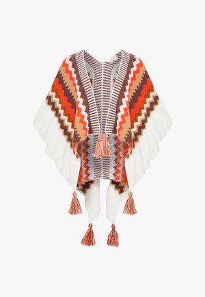 Pestrobarevný tkaný pončo se zigzag vzory v červené, hnědé a krémové barvě, s třásněmi na lemu a výstřihem ve tvaru písmene V.