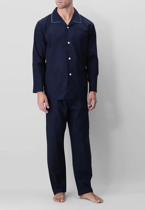 Set di pigiami blu navy realizzato in tessuto morbido. Maglietta a maniche lunghe con bordini bianchi, cinque bottoni e due tasche. Pantaloni abbinati, vestibilità regolare.