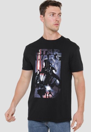 Black cotton t-shirt featuring a graphic design of a character with a lightsaber, text "Star Wars" in a distressed style above the image.