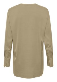 Chemise beige à manches longues avec poignets boutonnés vue de dos, avec un col simple et une texture de tissu lisse.