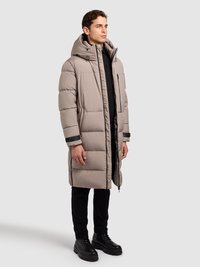 Puffer jakna svijetlo bež boje, s kapuljačom, prednjim patentnim zatvaračem i dva bočna džepa. Materijal je gladak, s prošivenim dijelovima za izolaciju.