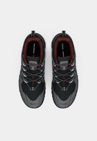 Gray and black hiking shoes with textured surfaces, reflective laces, padded collars, and rubber soles. Features a red interior and logo accents.