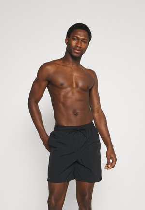 Pantaloni da bagno neri con vita elasticizzata e cordoncino. Tessuto leggero con una texture liscia. Nessun motivo visibile o dettagli in metallo.
