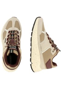 Beige and brown sneakers with a textured upper, lace fastening, contrasting maroon accents, and speckled cream outsole.