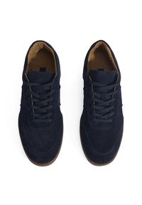 Navy suede sneakers with flat laces, rounded toe, rubber sole, and light brown interior lining. Smooth texture with minimal stitching accents.