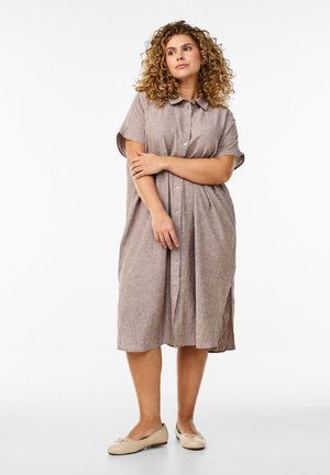 Brown, short-sleeve, button-up dress with a relaxed fit, knee-length hem, and side slits. Made of light, textured fabric. Flats with bow accents.