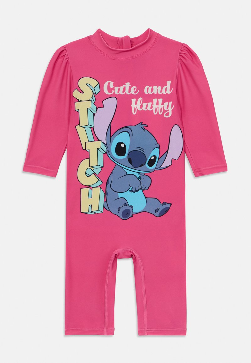 Ružičasti kombinezon s dugim rukavima, s grafikom Stića, uz tekst "Slatko i pahuljasto" u šarenim, podebljanim slovima.