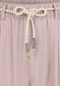 Light purple linen pants with an elastic waistband and a braided cream drawstring, featuring a small decorative charm at the end.